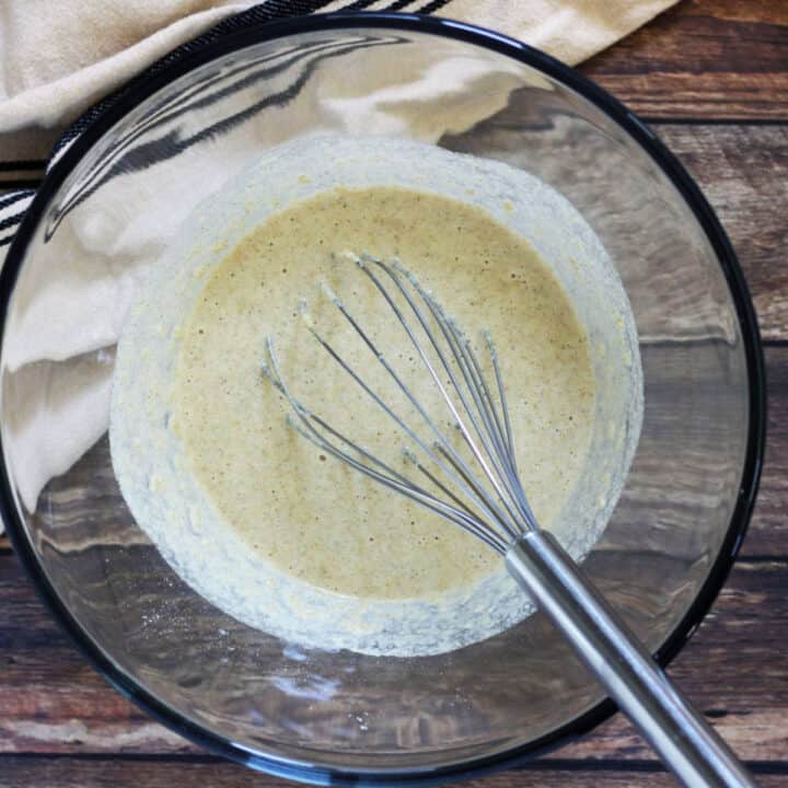 whisk in batter in glass bowl