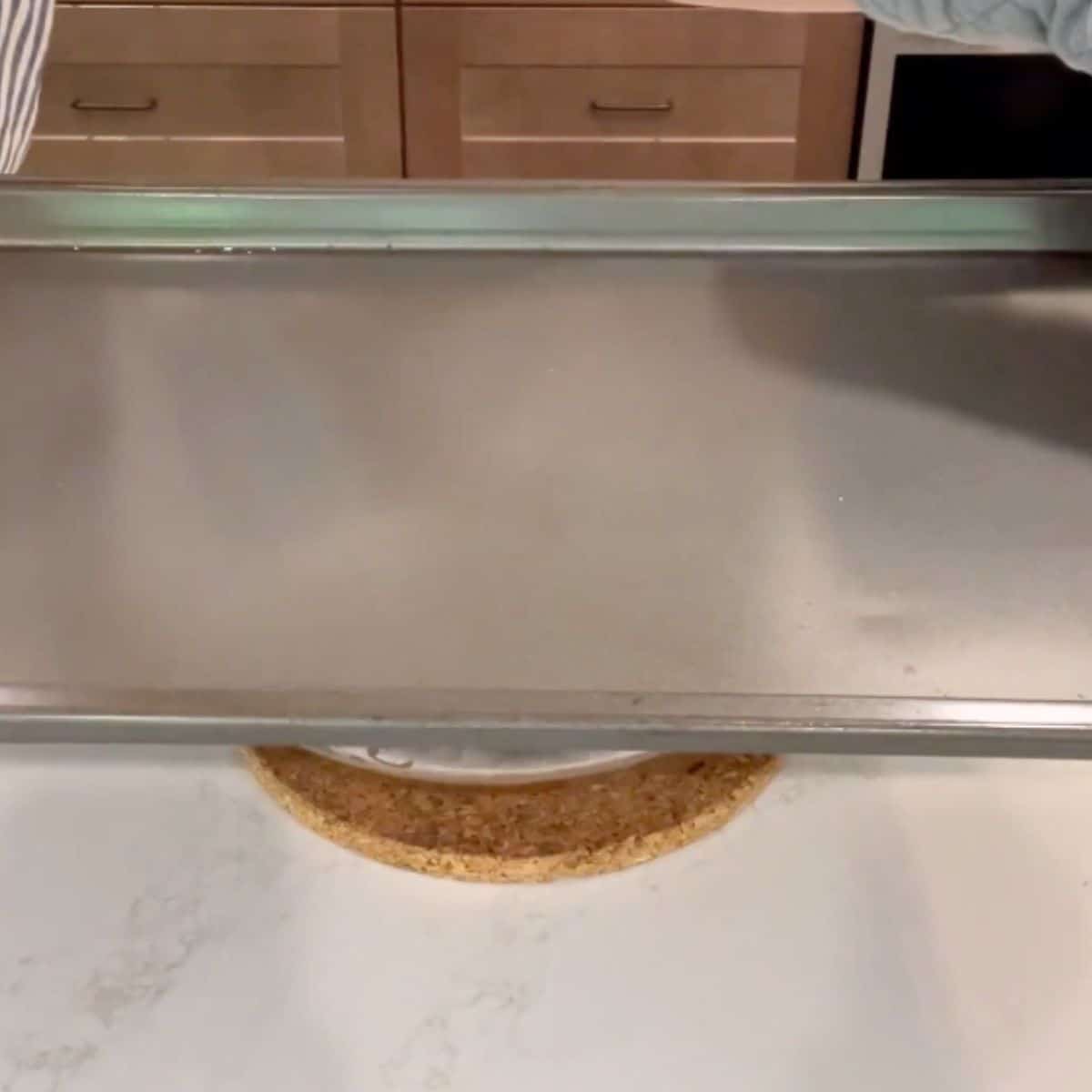 baking sheet resting on bowl.