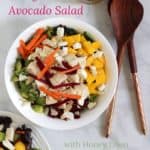 chunks of chicken, mango, and avocado with slivers of carrot and beet on lettuce and kale with text
