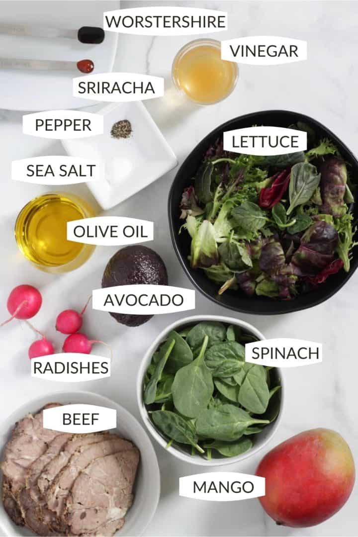 all of the ingredients for the beef salad set out in small bowls seen from above