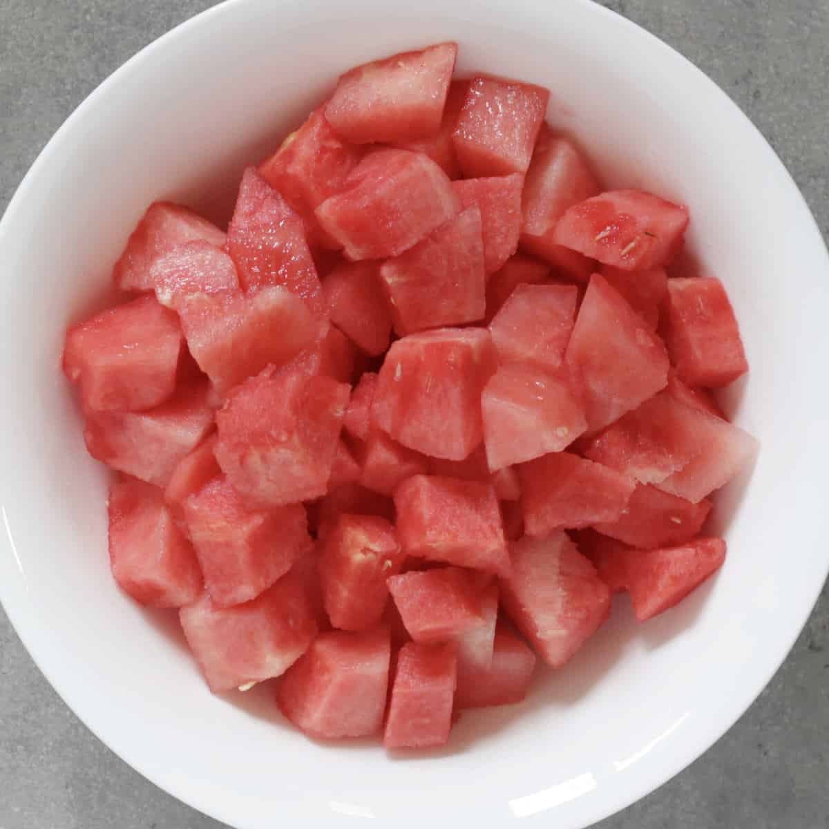 chunks of watermelon in white bowl