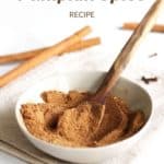 golden, brown spice mix stirred with wooden spoon on white background with title text