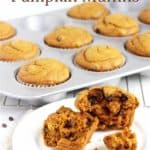 broken pumpkin muffin on white plate in front of more muffins in tin