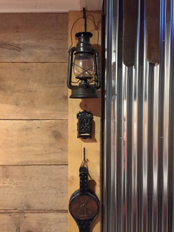 old kole oil lantern and fire accessories hanging on wall