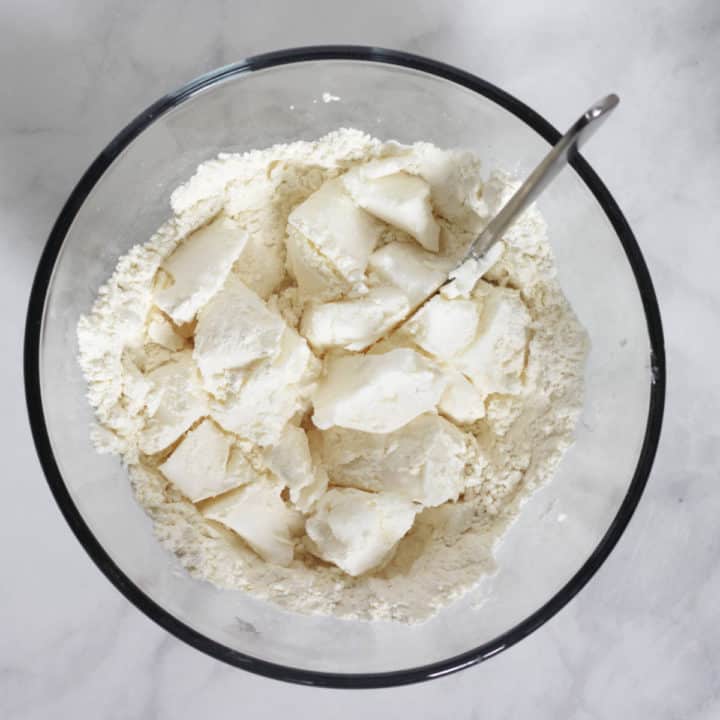 table knife cut into chunks of lard in dry flour mixture