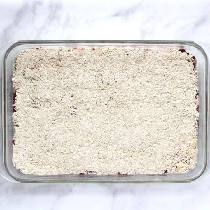 crumb mixture covers the filling in glass baking dish