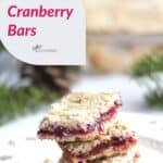 stack of cranberry bars on white plate with title text