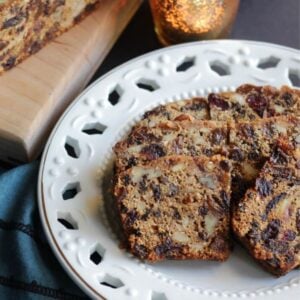 sliced fruitcake with nuts on lacy, white plate