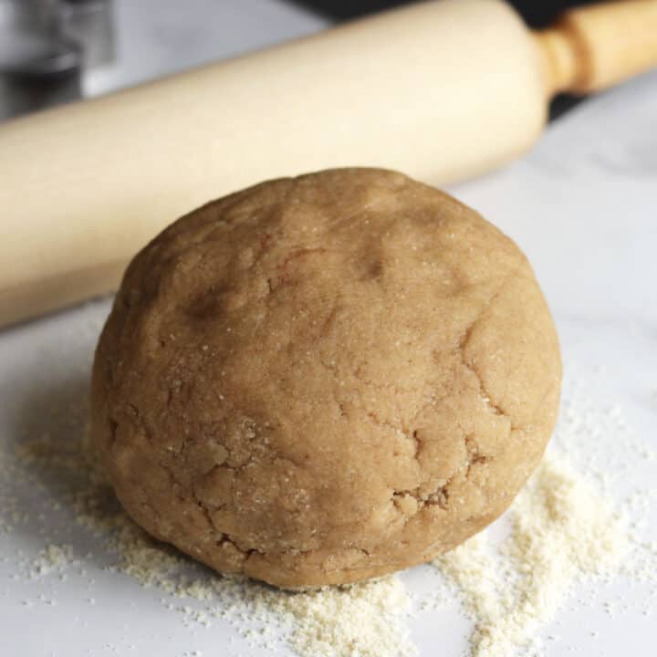 round ball of brownish dough for soft gingerbread cookie recipe in front of rolling pin