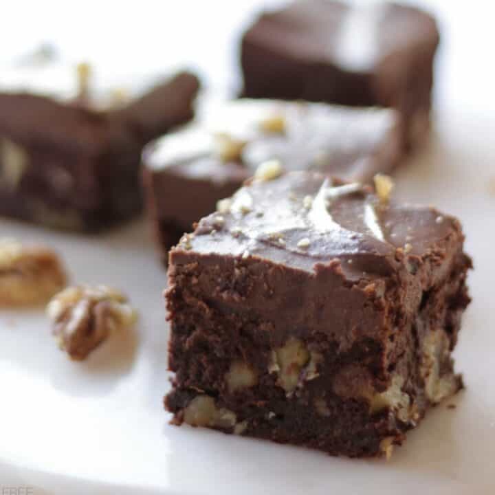 closeup of a square, chunky sweet potato brownie with walnuts and chocolate frosting