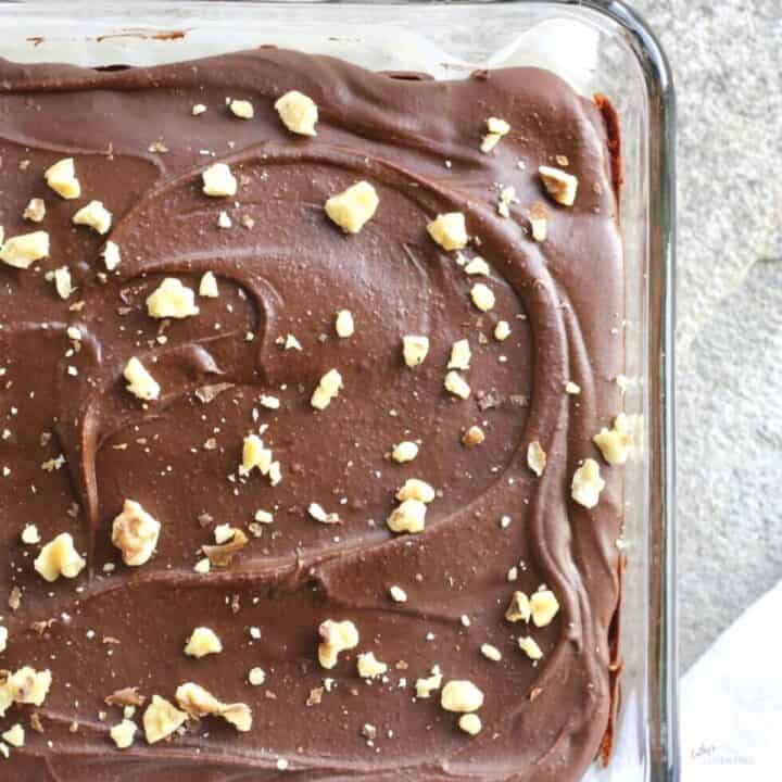 chopped walnuts sprinkled over surface of frosted brownies