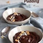 two bowls of chocolate avocado pudding garnished with coconut flakes and chopped nuts