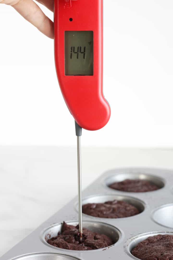 red thermometer inserted into small cake reads 144 degrees F.