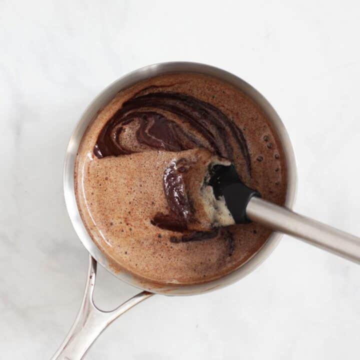 foamy egg mixture partially stirred into melted chocolate