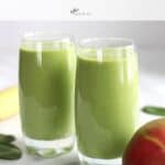 two glasses of green smoothie with partial mango and banana showing with title text