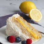 wedge of lemon cake with lemon filling and white frosting on white plate with berries, lemon in background, title text