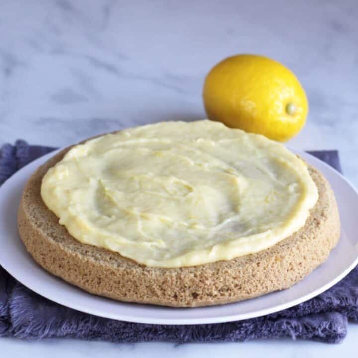 yellow lemon curd spread over top of cake layer