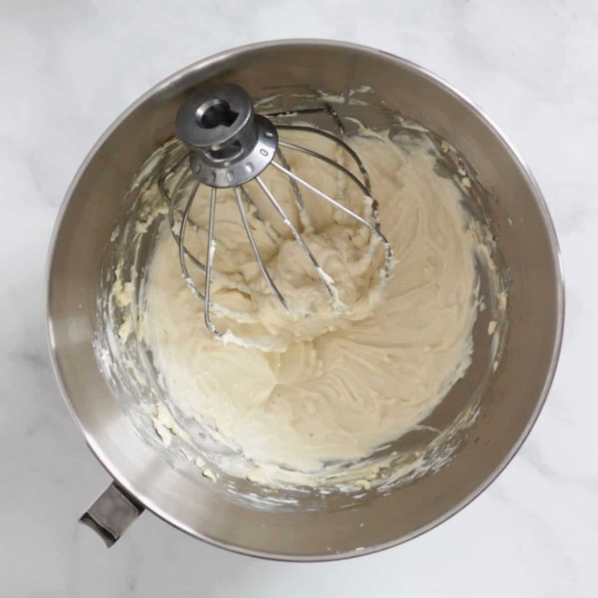 beaten cream cheese mixture in bottom of mixing bowl with whisk