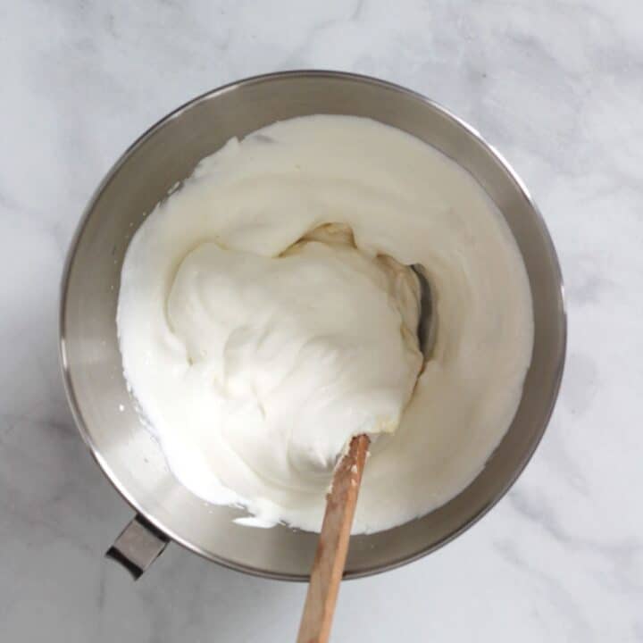 fluffy white mixture in bowl with wooden spatula