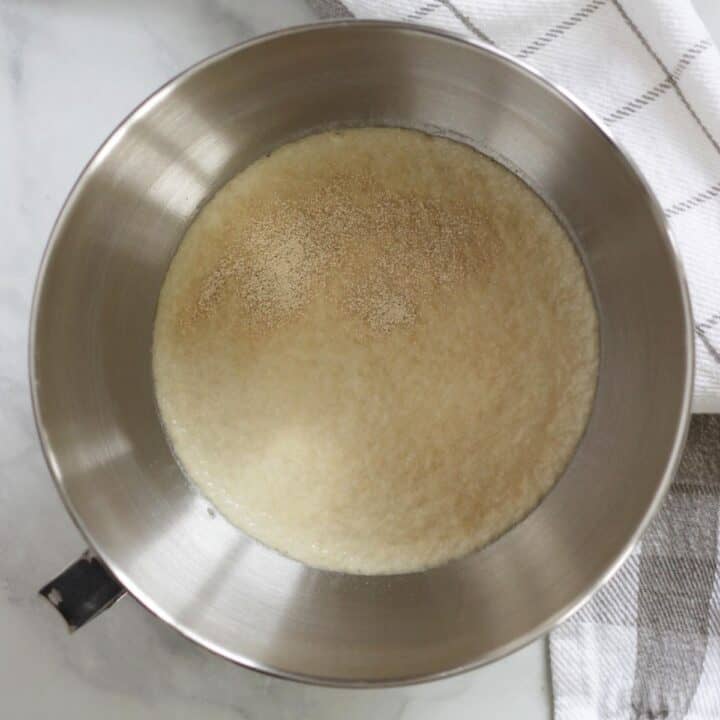 foamy yeast on liquid in bowl of stand mixer