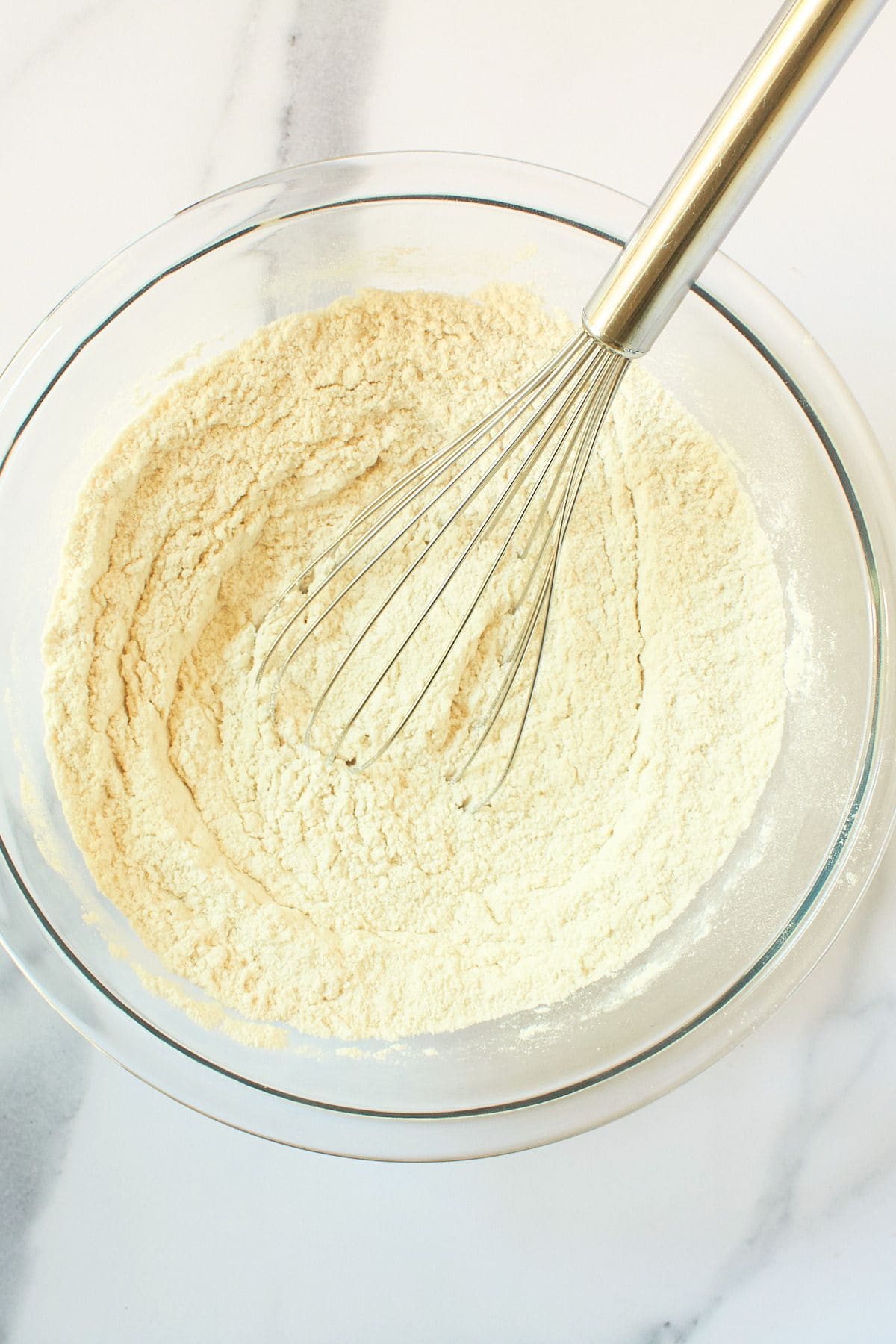 white flour mixture in bowl with whisk.