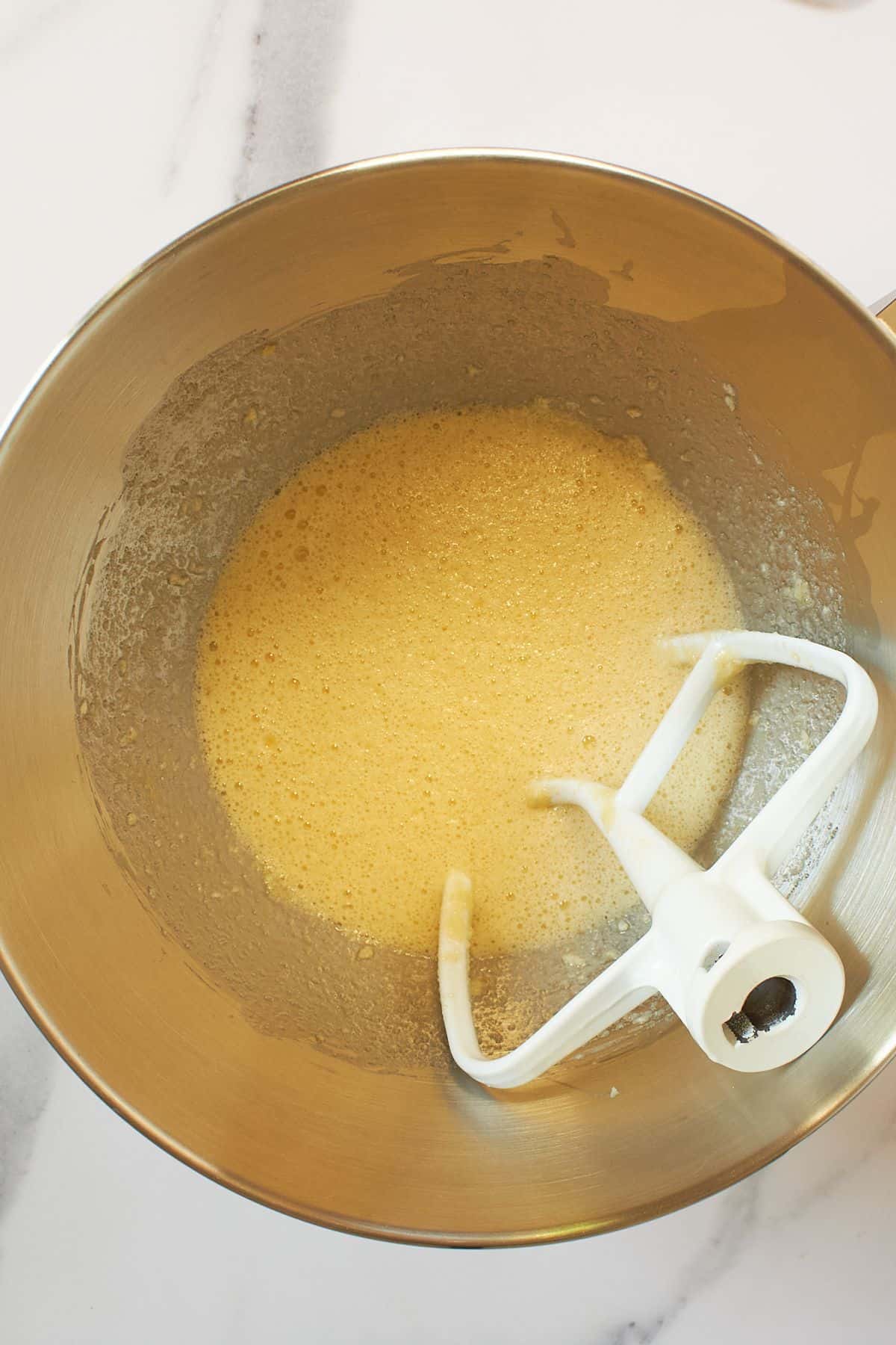 beaten eggs in mixing bowl with paddle mixer.