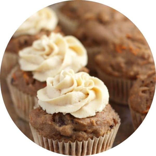 carrot cake muffins with swirls of frosting on top