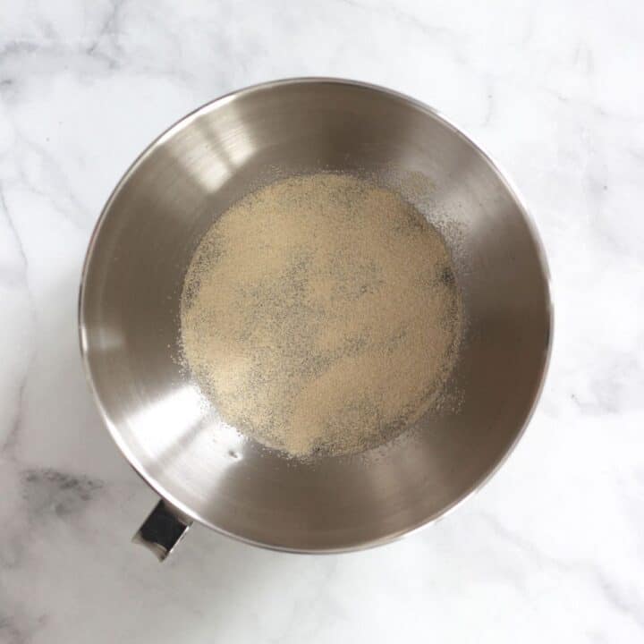 yeast sprinkled over liquid in bowl of stand mixer