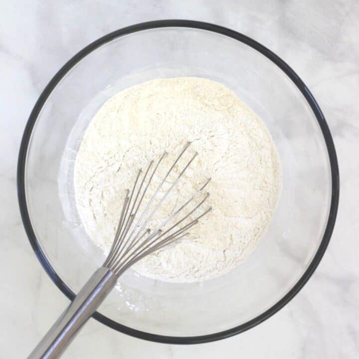 whisk in white flour mixture in glass bowl