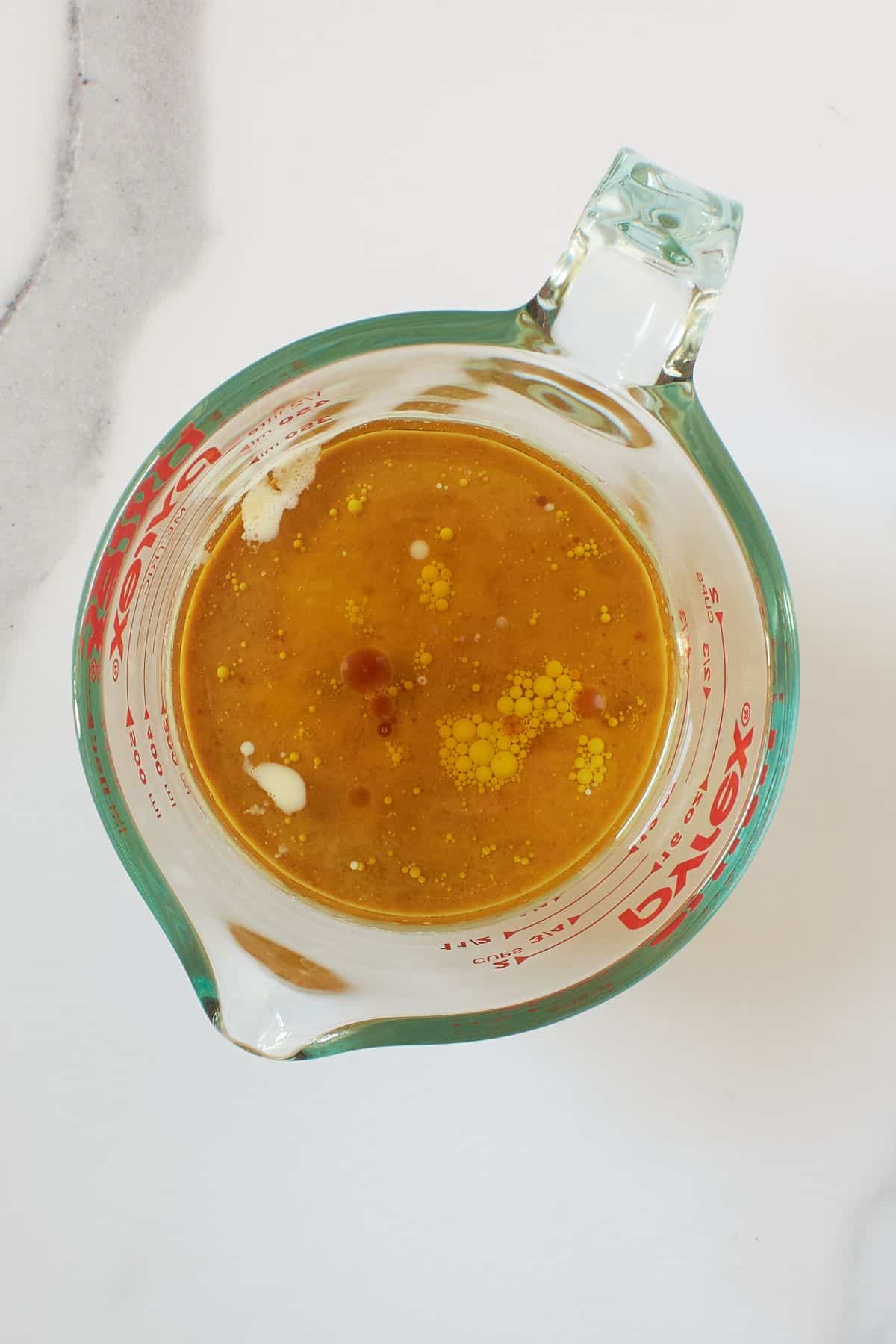 oil and milk mixture in measuring cup.