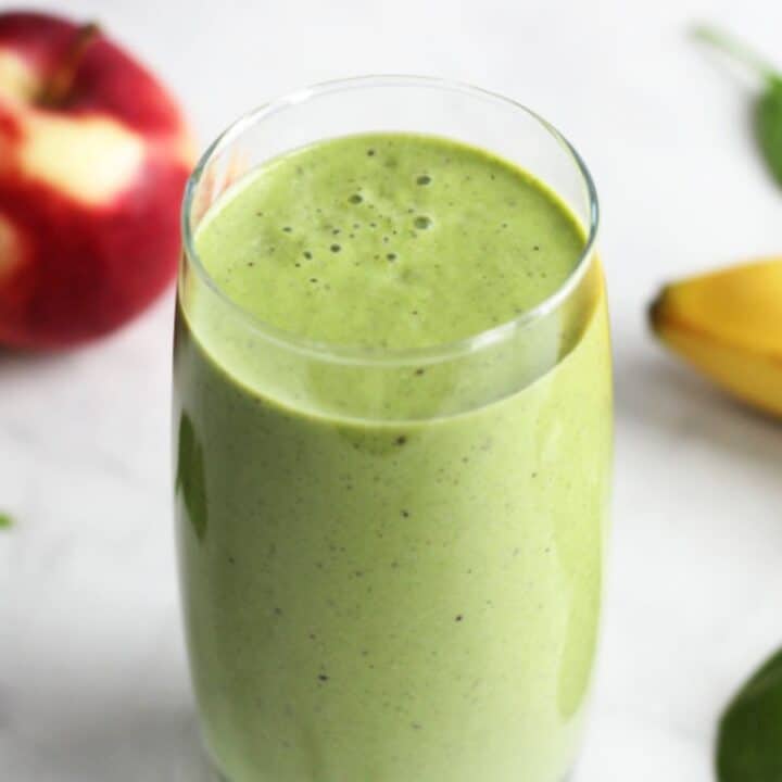 looking down into green smoothie with bubbles on surface