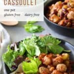 bean cassoulet in black bowls garnished with green leaves
