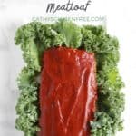 top down view of loaf of meatloaf slathered in barbecue sauce and sitting in a bed of greens, with title text