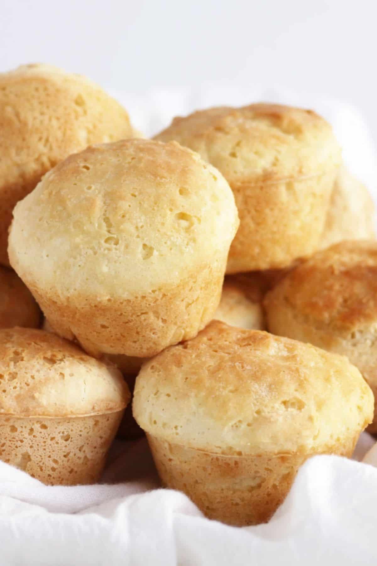 fresh golden dinner rolls piled on top of one another