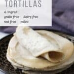 one rolled tortilla sitting on a stack of flat ones on a black plate with lavender napkin in background, and title text