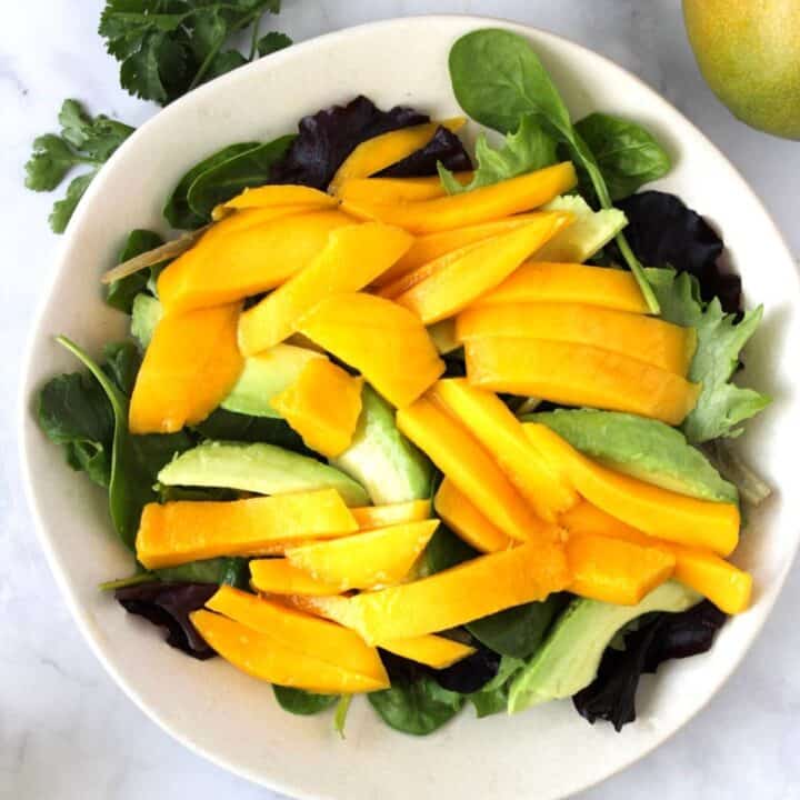 slices of mango and avocado on lettuce leaves