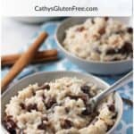 two bowls of raisin-studded rice pudding on blue placemat with a couple cinnamon sticks.