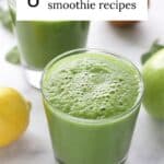 two glasses of healthy green smoothies surrounded by various fruits