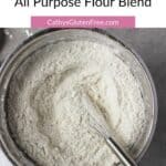 stainless bowl of gluten free flour with a whisk in it, as seen from above, with title text.