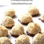 craggy, golden gluten free coconut macaroons dipped in chocolate sitting randomly on white surface, with title text.