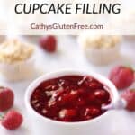 white ramekin filled with shiny red strawberry filling, surrounded by whole strawberries and cupcakes. Title text "gluten free STRAWBERRY CUPCAKE FILLING CathysGlutenFree.com".