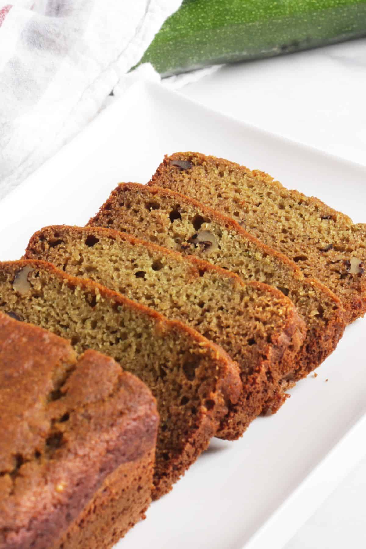 slice zucchini bread on white plate.
