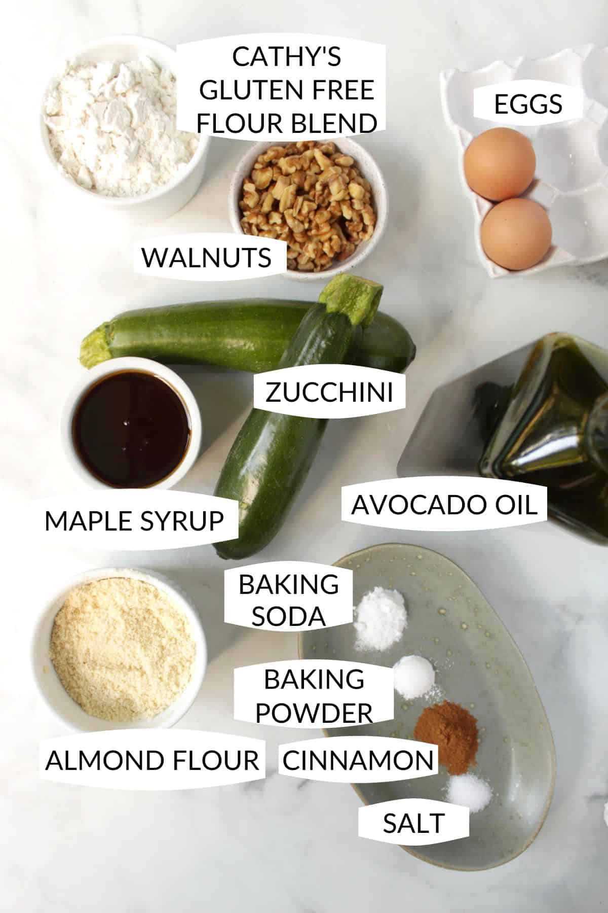 looking down on ingredients for gluten free zucchini bread in small bowls, with labels.