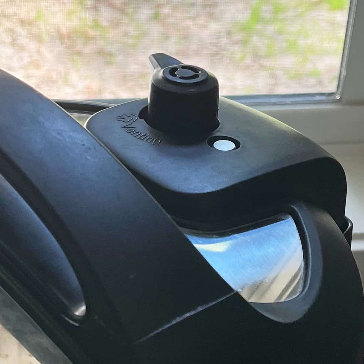 Instant Pot pressure button in upward, sealed position.