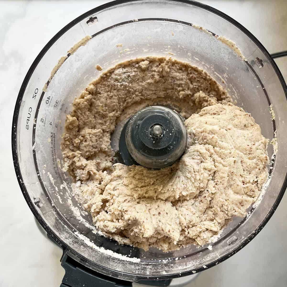 moist dough, balled up, in the bowl of a food processor.