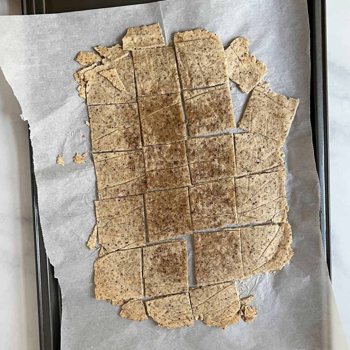 partially baked, cut square crackers on parchment paper.