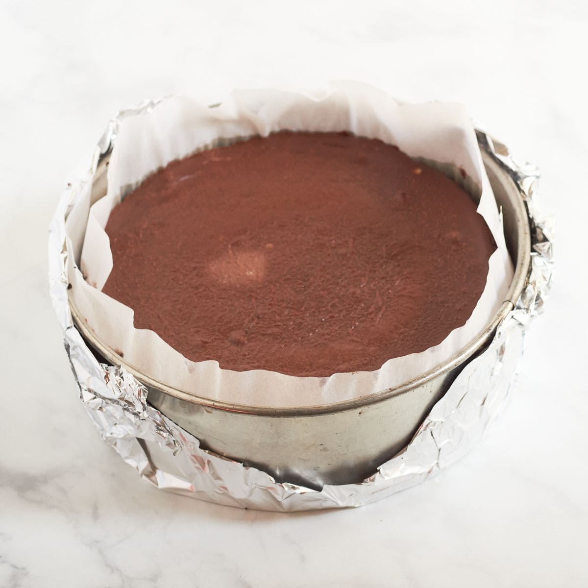 baked chocolate cheesecake in pan.