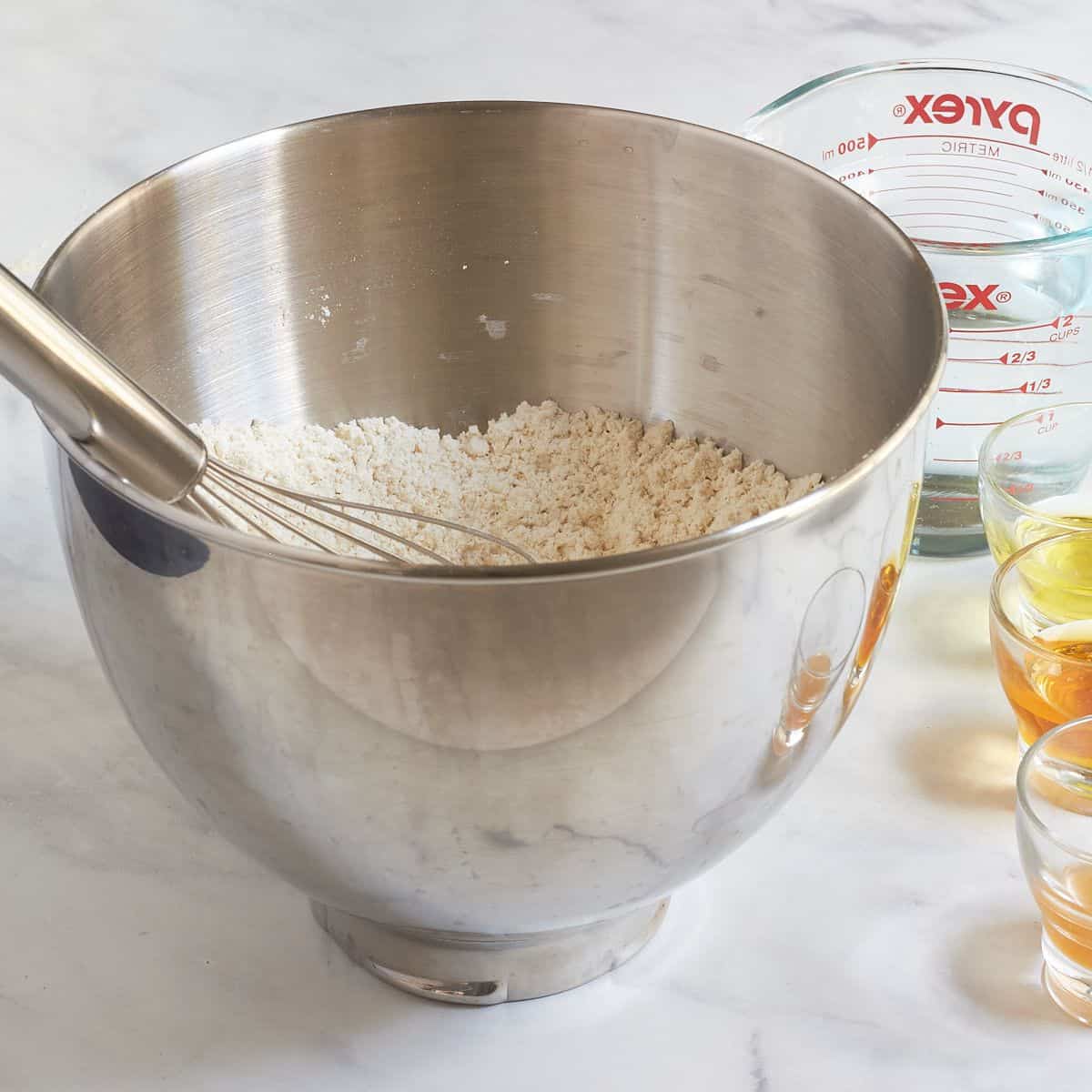 dry flour in bowl of stand mixer with a whisk.