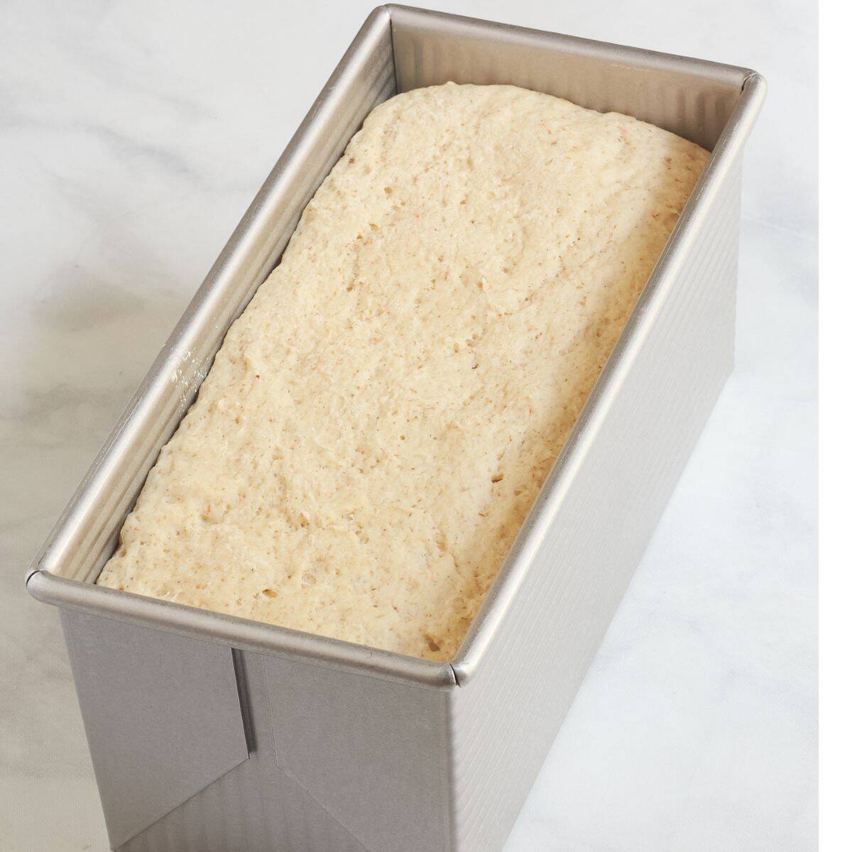 moist dough in metal bread pan.