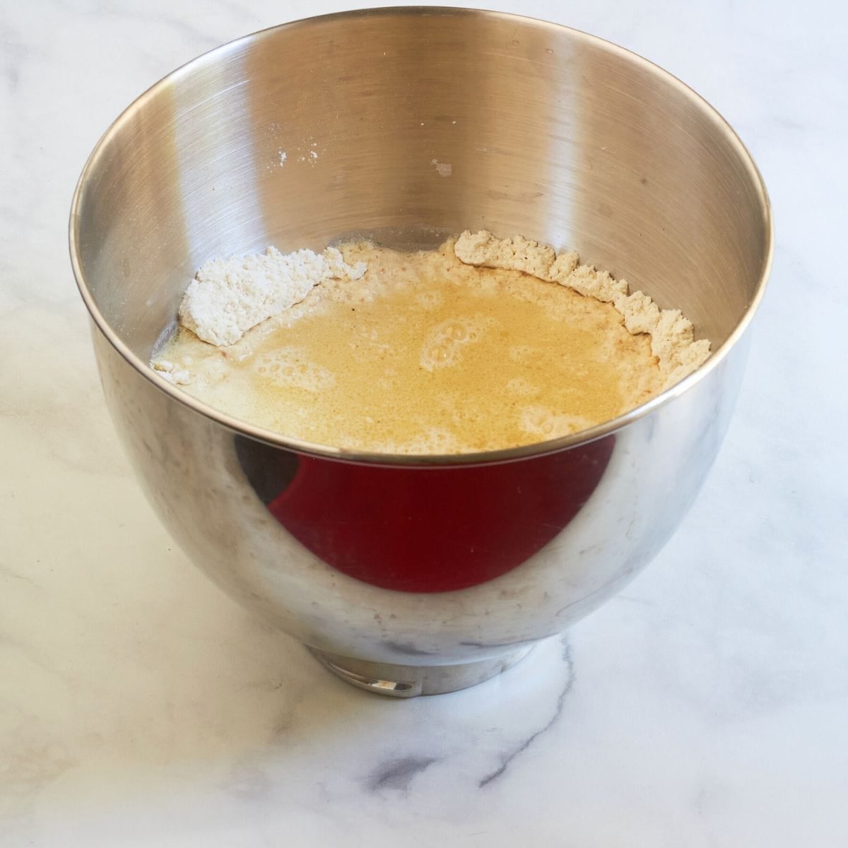 liquid in well in dry ingredients in the bowl of a stand mixer.